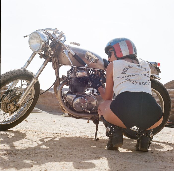 A playful frame from Girls on a motorcycle — online in Accra